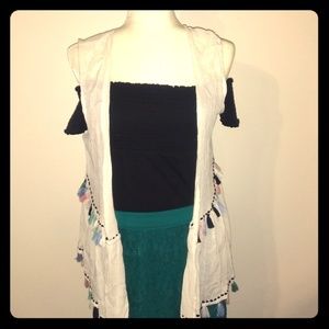 Off the shoulder top, lace skirt, and tassle vest.